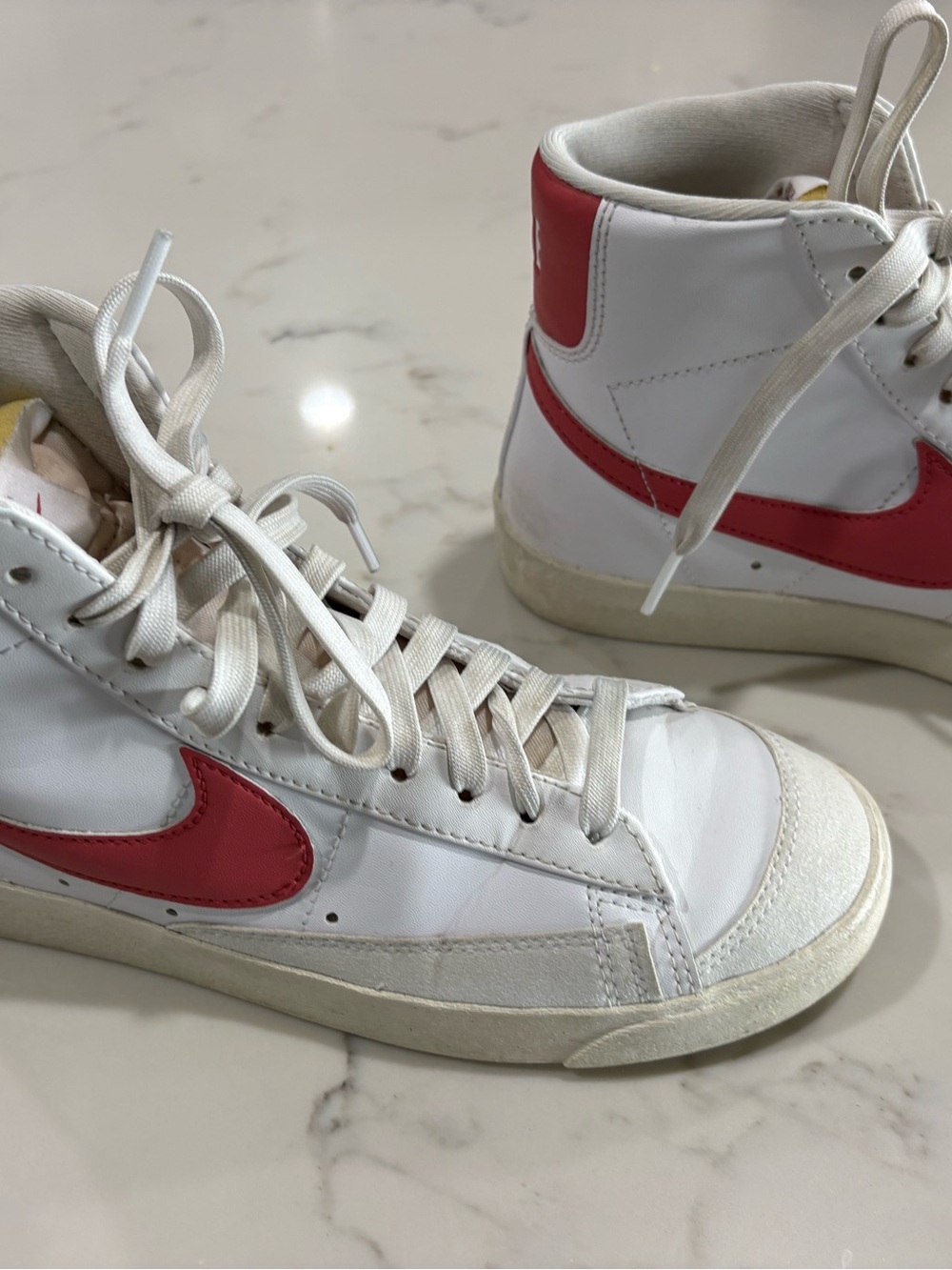Nike Women’s White High-Top Sneakers with pink Swoosh